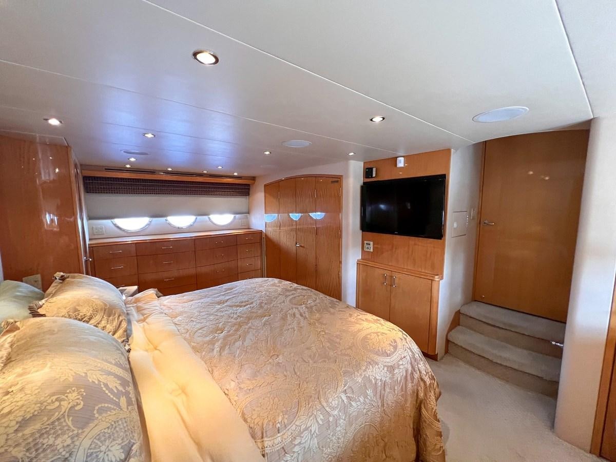 a bedroom with a bed and a television aboard DESTINI IV Yacht for Sale