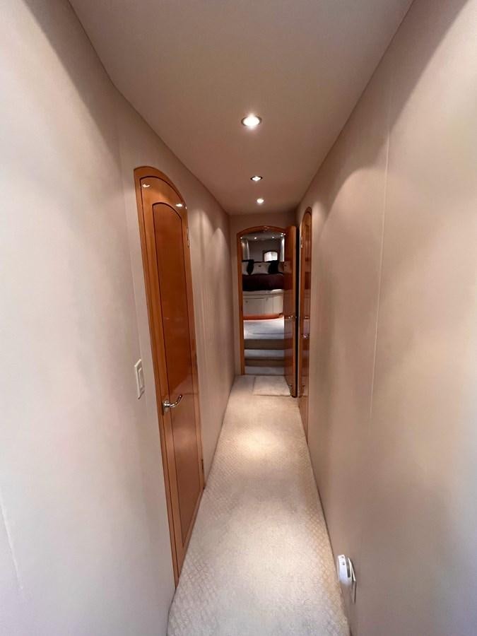 a hallway with a door and a wood door aboard DESTINI IV Yacht for Sale