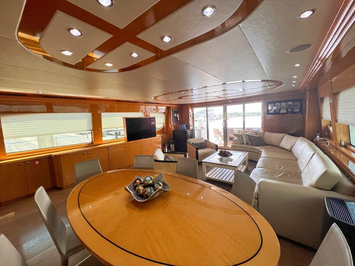 a large living room with a large table and chairs aboard DESTINI IV Yacht for Sale