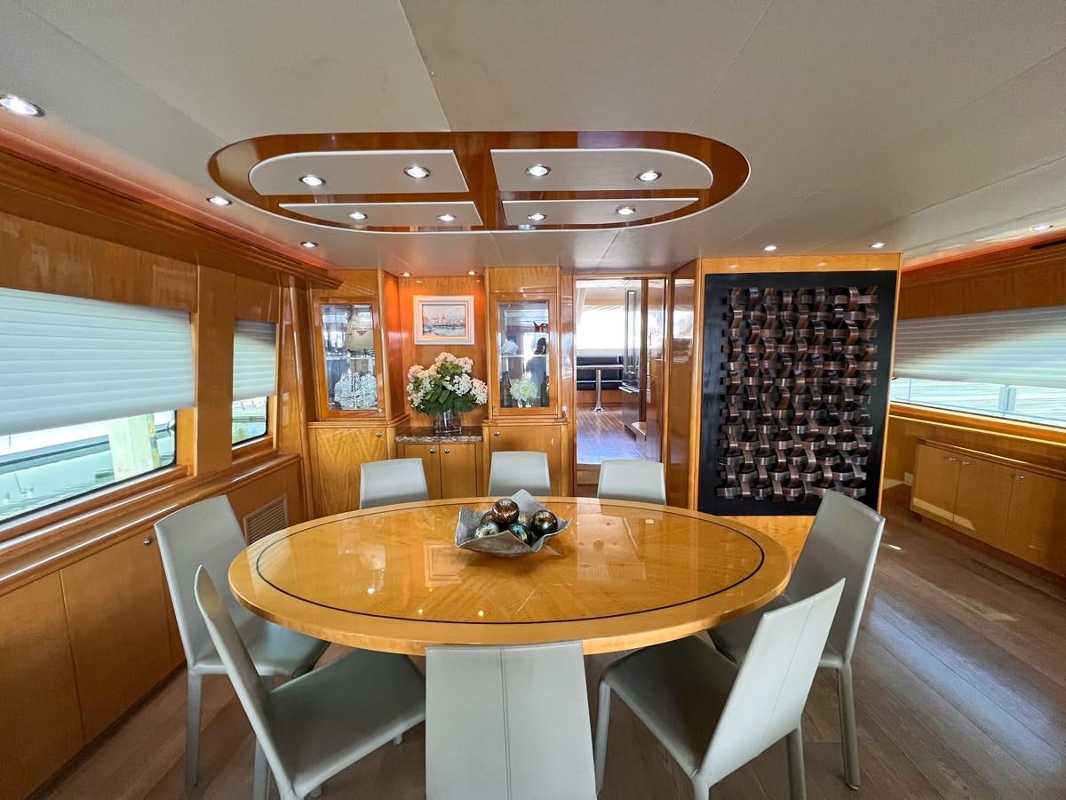 a dining room with a table and chairs aboard DESTINI IV Yacht for Sale
