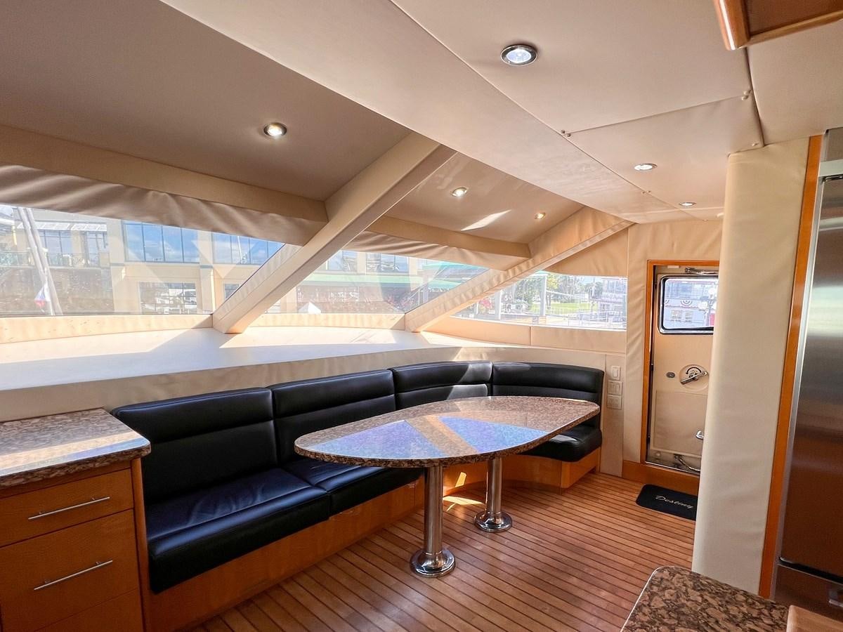 a living room with a couch and a coffee table aboard DESTINI IV Yacht for Sale