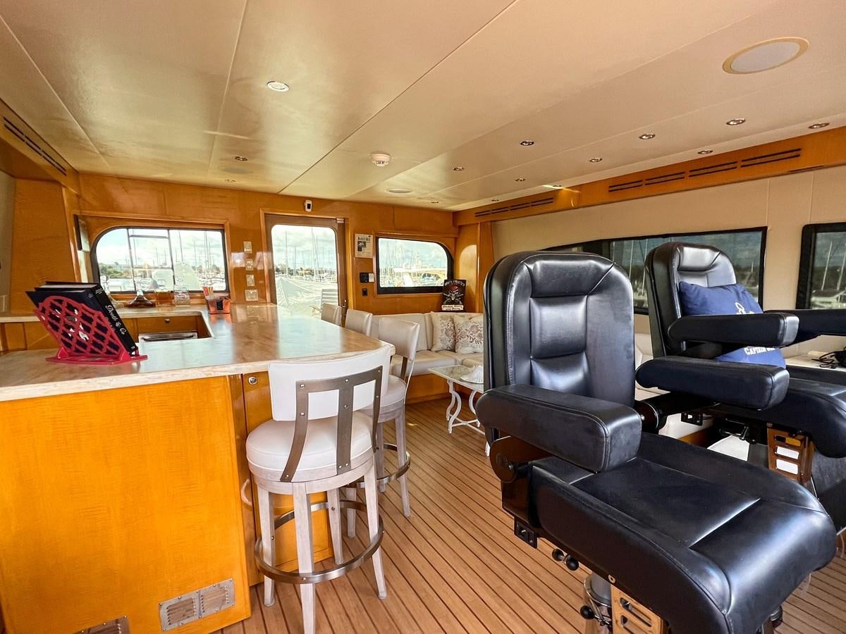 a room with chairs and tables aboard DESTINI IV Yacht for Sale