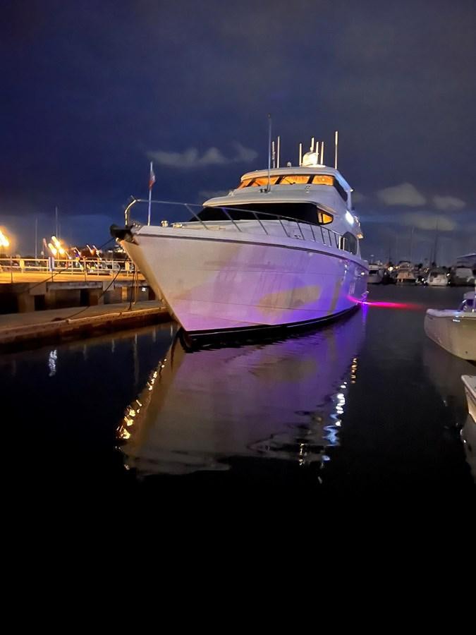 a large white boat sits at a dock aboard DESTINI IV Yacht for Sale