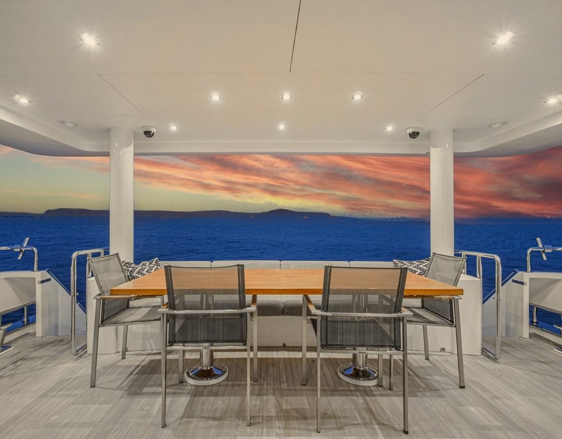 a pool with tables and chairs aboard SEASEID Yacht for Sale