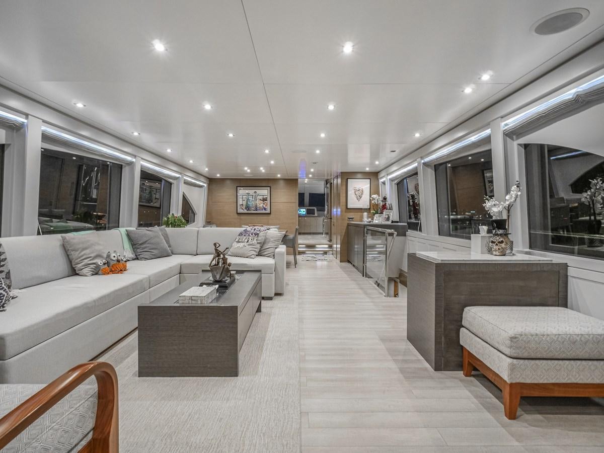 a living room with a white couch aboard SEASEID Yacht for Sale