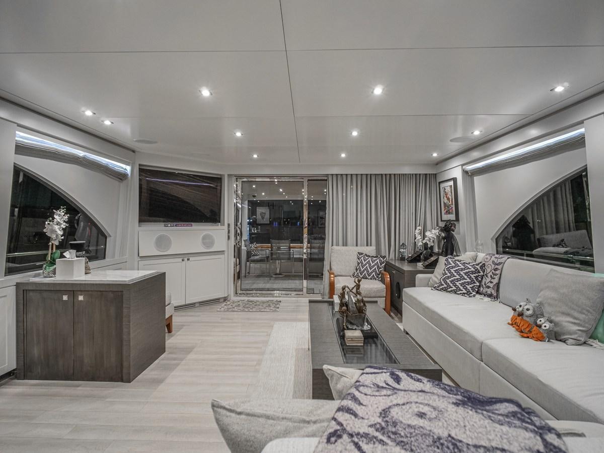 a living room with a white couch and a tv aboard SEASEID Yacht for Sale