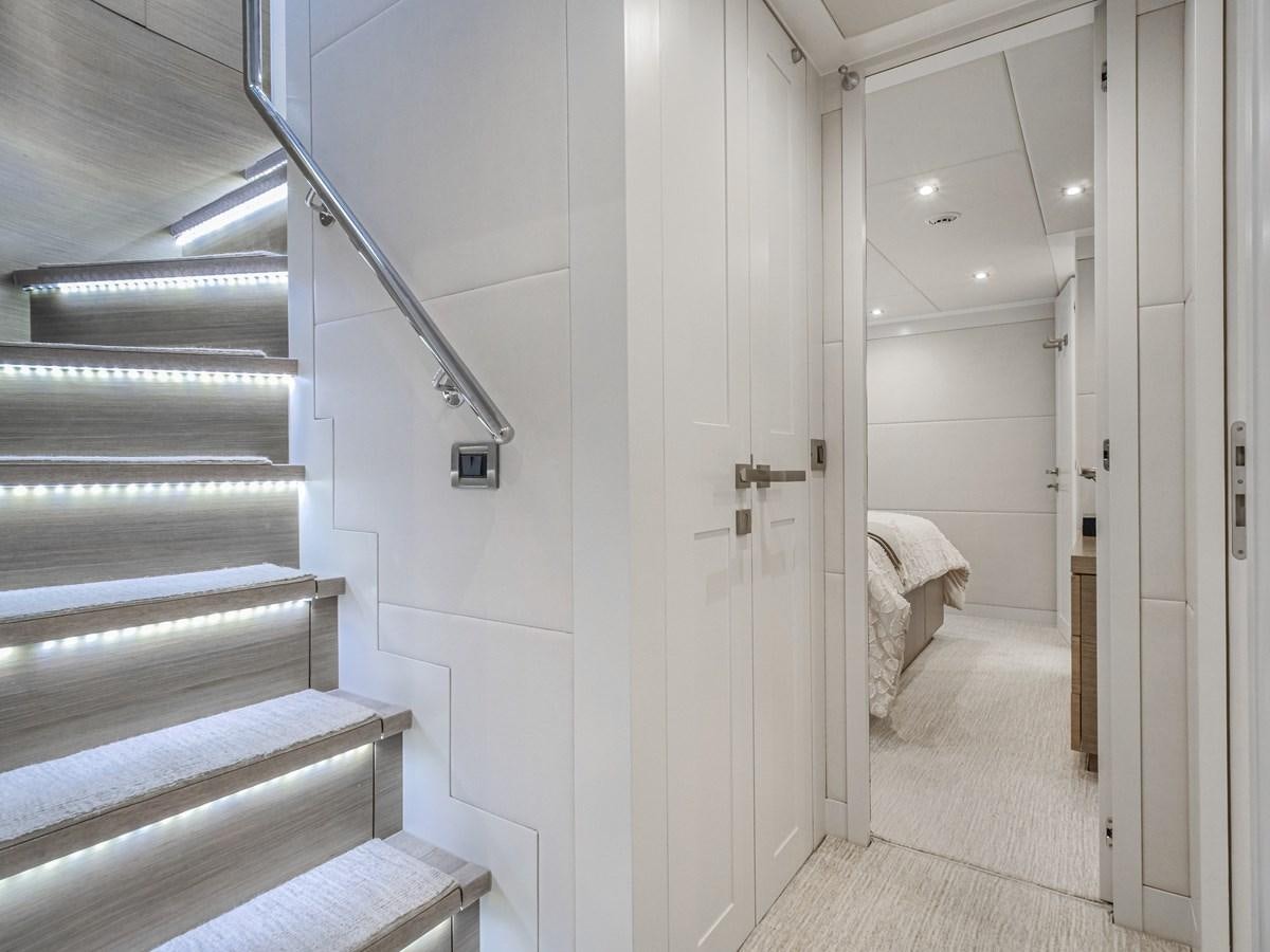 a white hallway with a bed aboard SEASEID Yacht for Sale