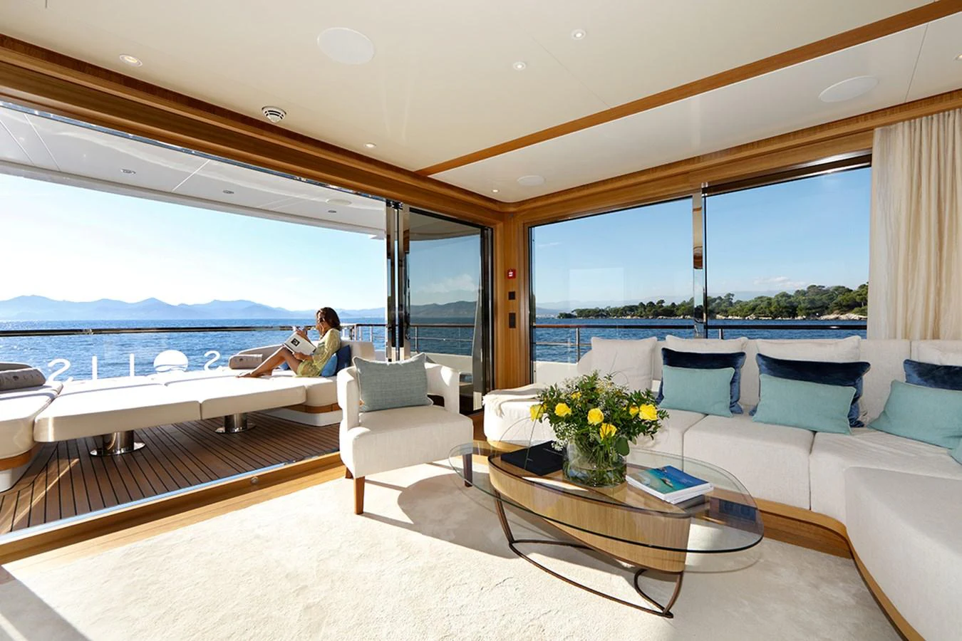 a living room with a large balcony aboard SOLIS Yacht for Charter
