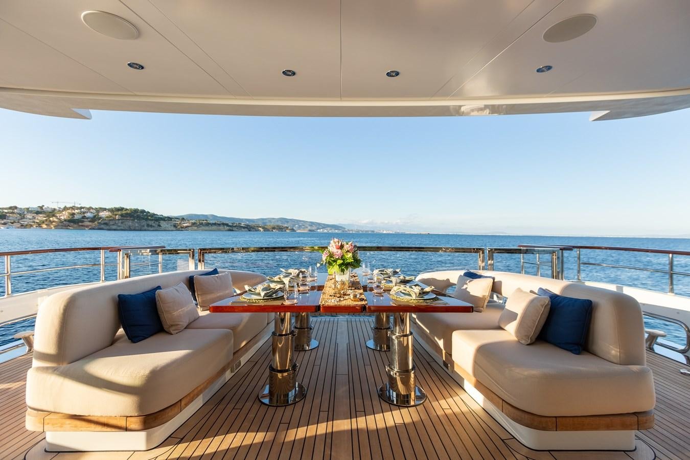 a living room with a table and couches aboard SOLIS Yacht for Sale