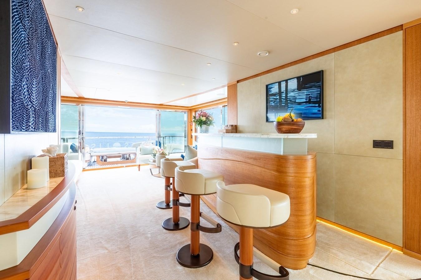 a room with a table and chairs aboard SOLIS Yacht for Sale