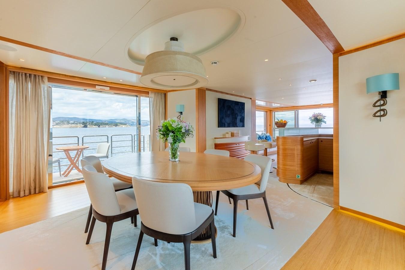 a dining table and chairs in a living room aboard SOLIS Yacht for Sale