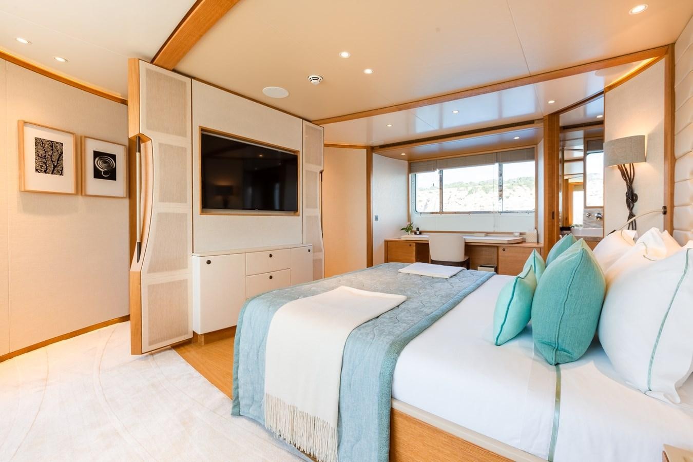 a bedroom with a bed and a television aboard SOLIS Yacht for Sale