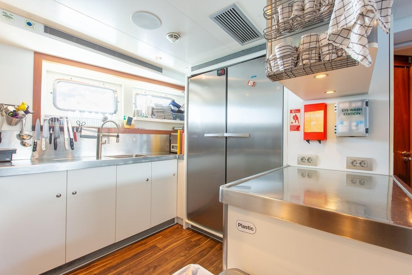 a kitchen with a stainless steel refrigerator aboard SOLIS Yacht for Sale