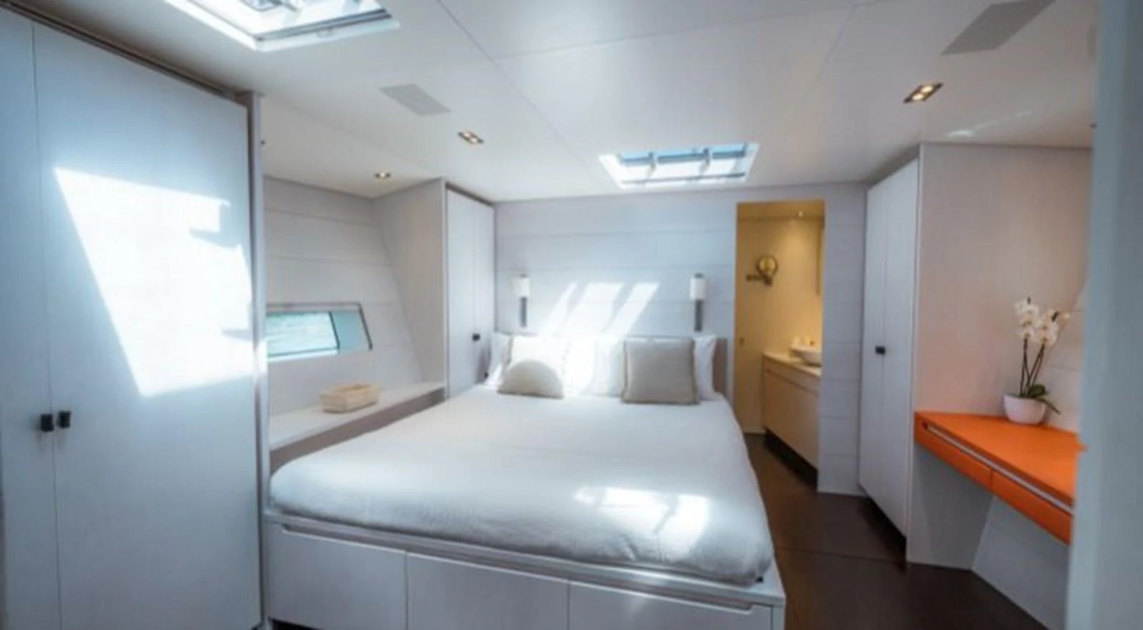 a bedroom with a bed and a desk aboard Y3K Yacht for Sale