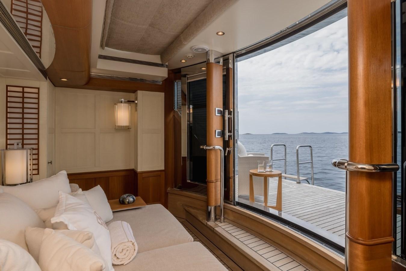 a room with a bed and a large window aboard BELLE ANNA Yacht for Sale