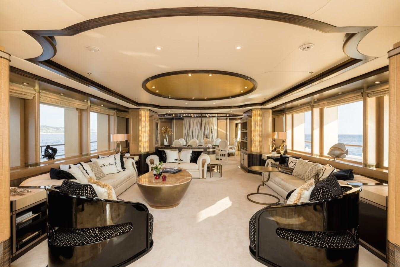 a large living room with a large chandelier aboard BELLE ANNA Yacht for Sale