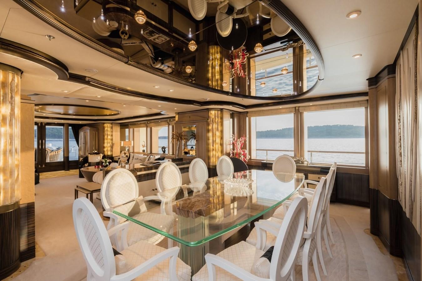 a room with tables and chairs aboard BELLE ANNA Yacht for Sale