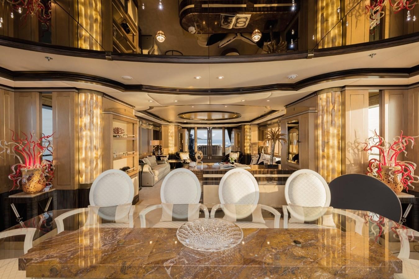 a large room with tables and chairs aboard BELLE ANNA Yacht for Sale