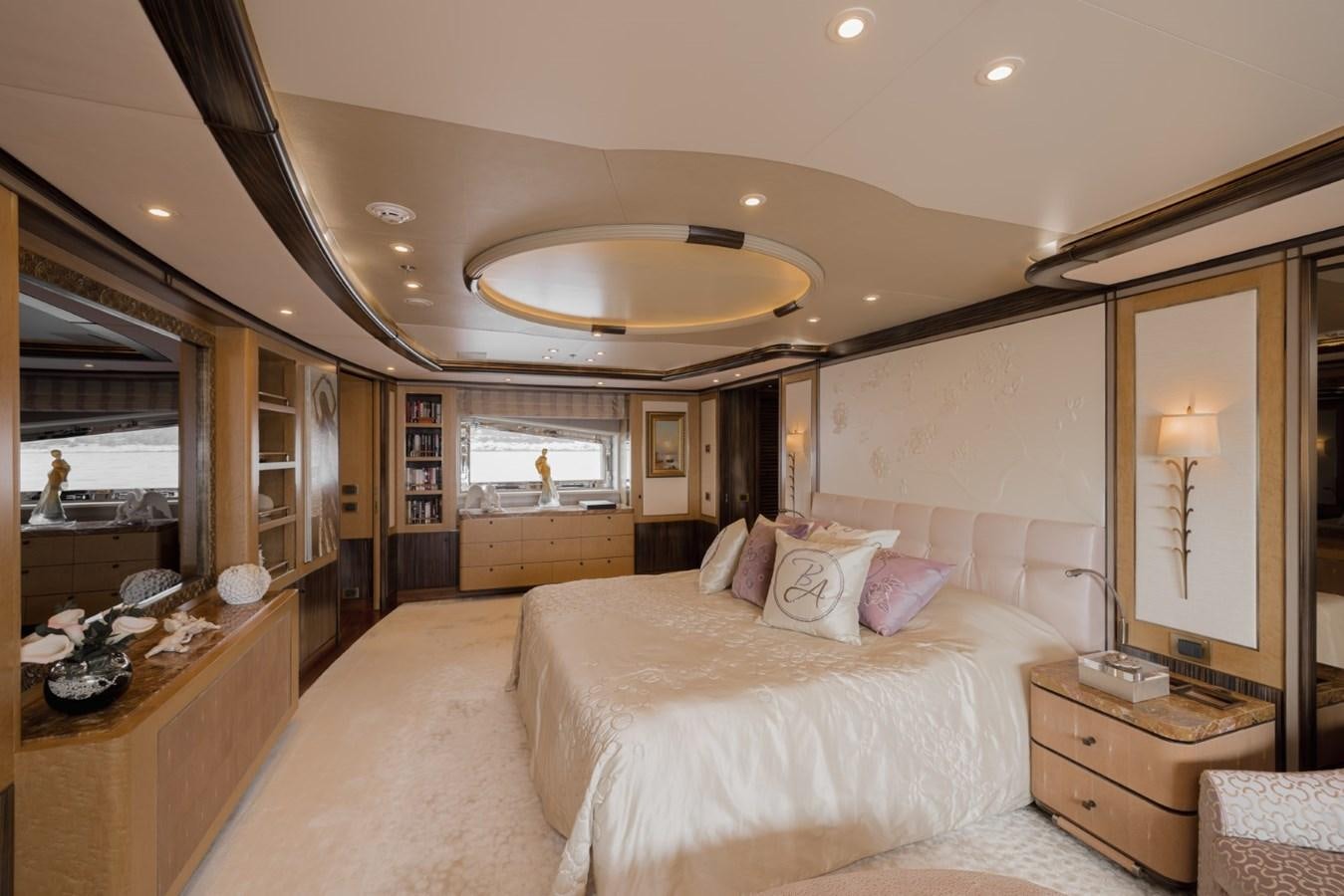 a large bedroom with a large mirror aboard BELLE ANNA Yacht for Sale
