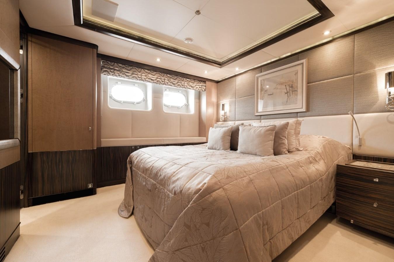 a bedroom with a bed and a mirror aboard BELLE ANNA Yacht for Sale