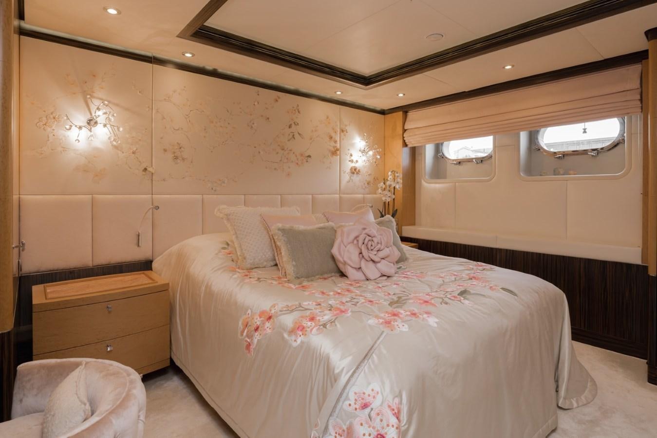 a bedroom with a bed and a dresser aboard BELLE ANNA Yacht for Sale
