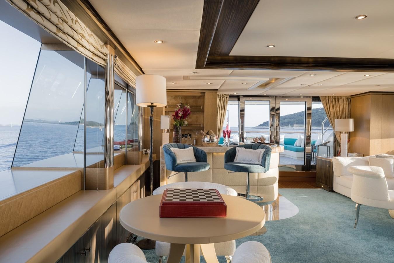 a room with a table and chairs aboard BELLE ANNA Yacht for Sale