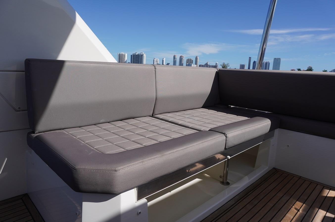 a white couch in a room aboard 2017 PRESTIGE 680  Yacht for Sale