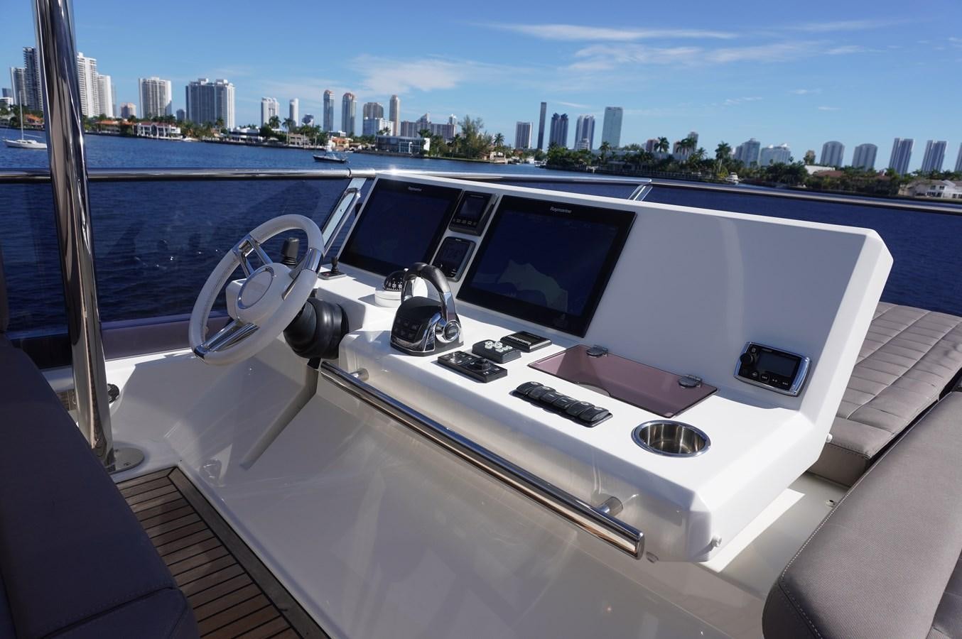 a white car with a screen and a keyboard on the front aboard 2017 PRESTIGE 680  Yacht for Sale