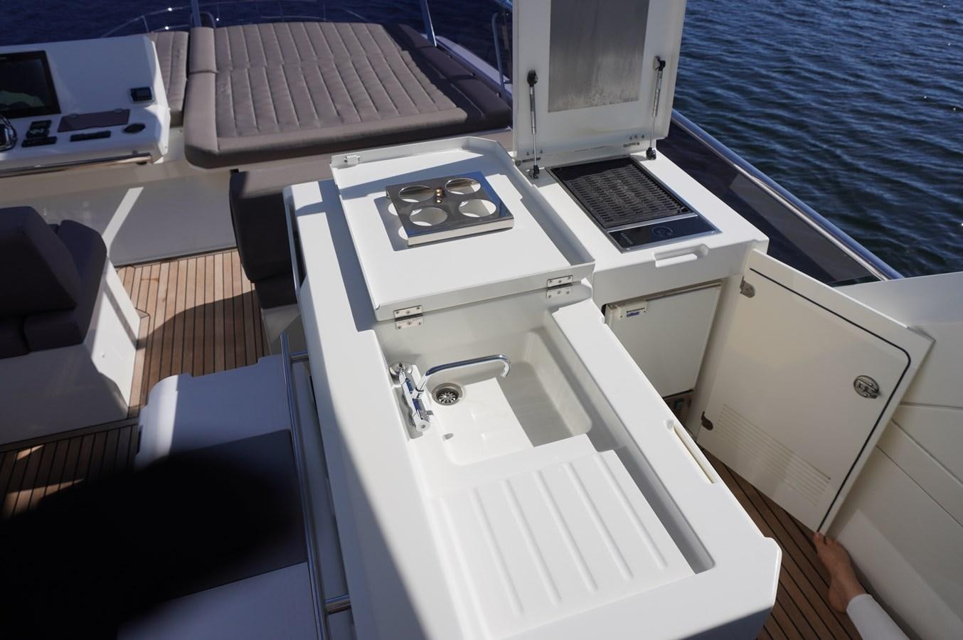 a boat with a laptop on the deck aboard 2017 PRESTIGE 680  Yacht for Sale
