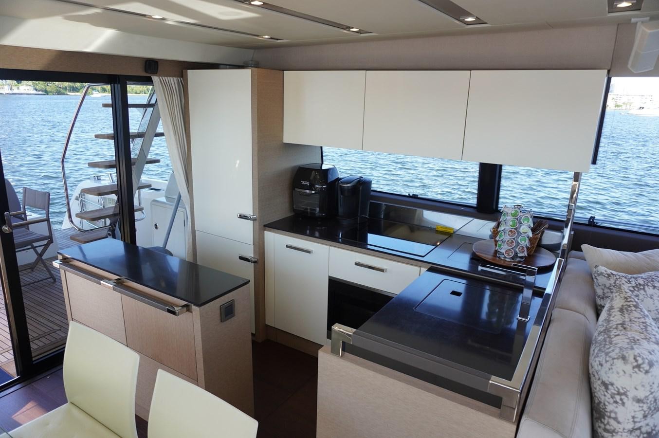 a kitchen with a large window aboard 2017 PRESTIGE 680  Yacht for Sale