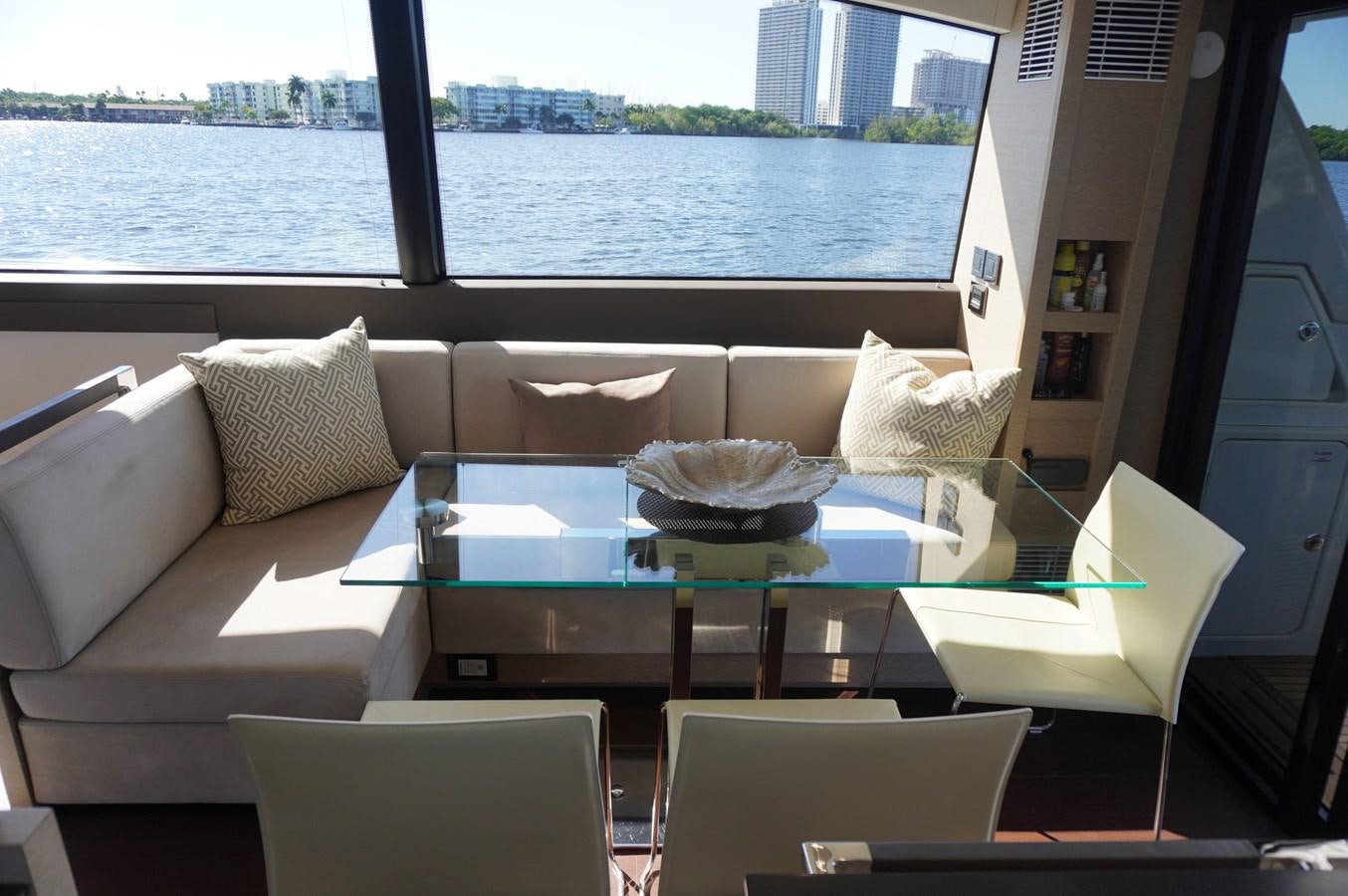 a table with chairs around it aboard 2017 PRESTIGE 680  Yacht for Sale