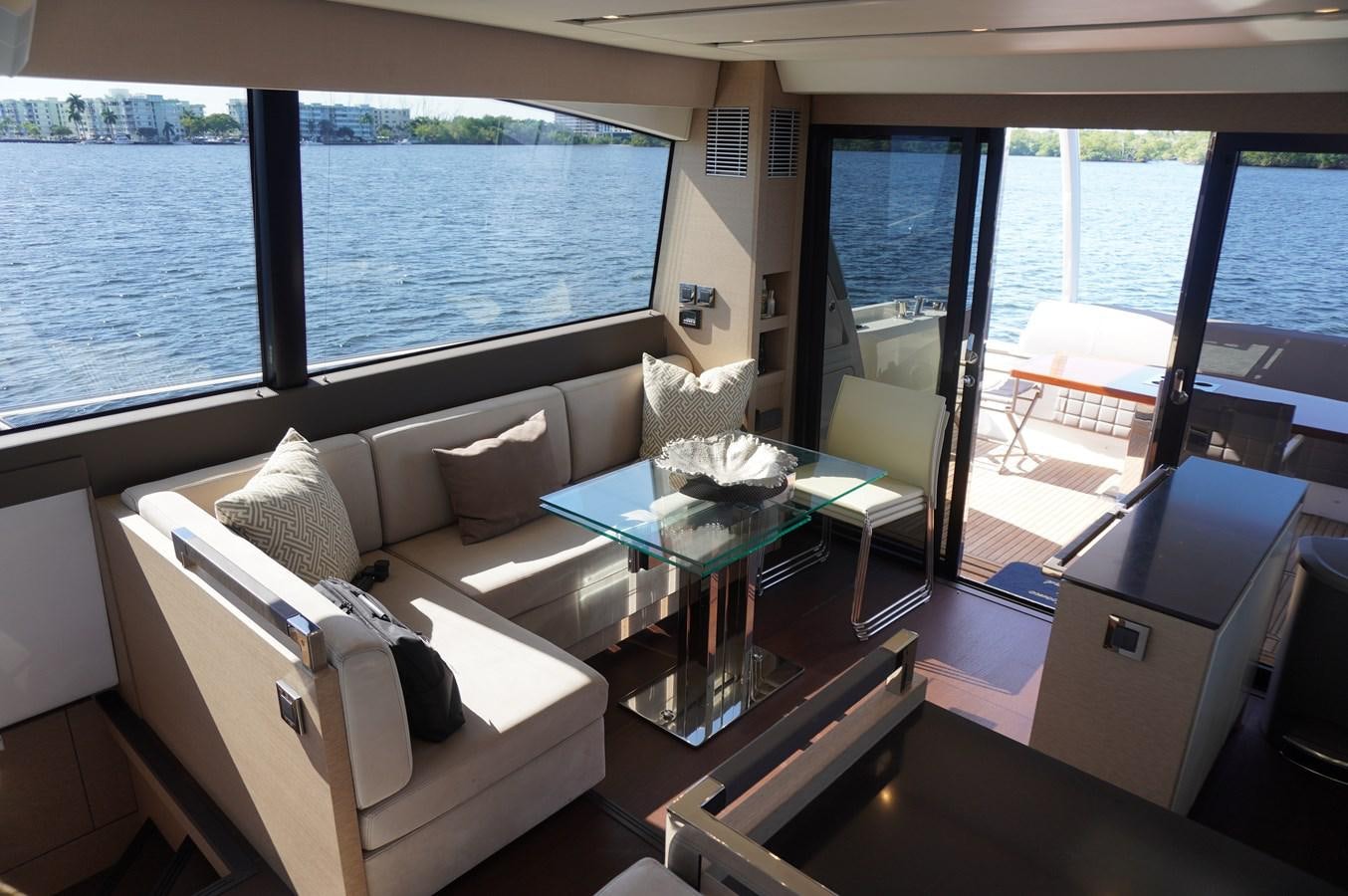 a living room with a large window aboard 2017 PRESTIGE 680  Yacht for Sale