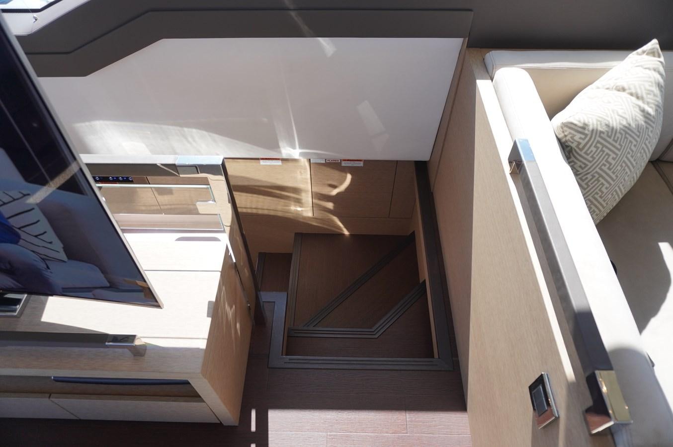 a room with a bed and a desk aboard 2017 PRESTIGE 680  Yacht for Sale