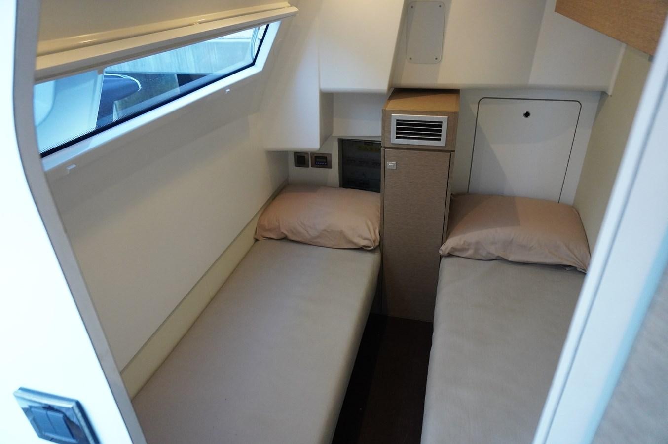 a room with beds and a window aboard 2017 PRESTIGE 680  Yacht for Sale