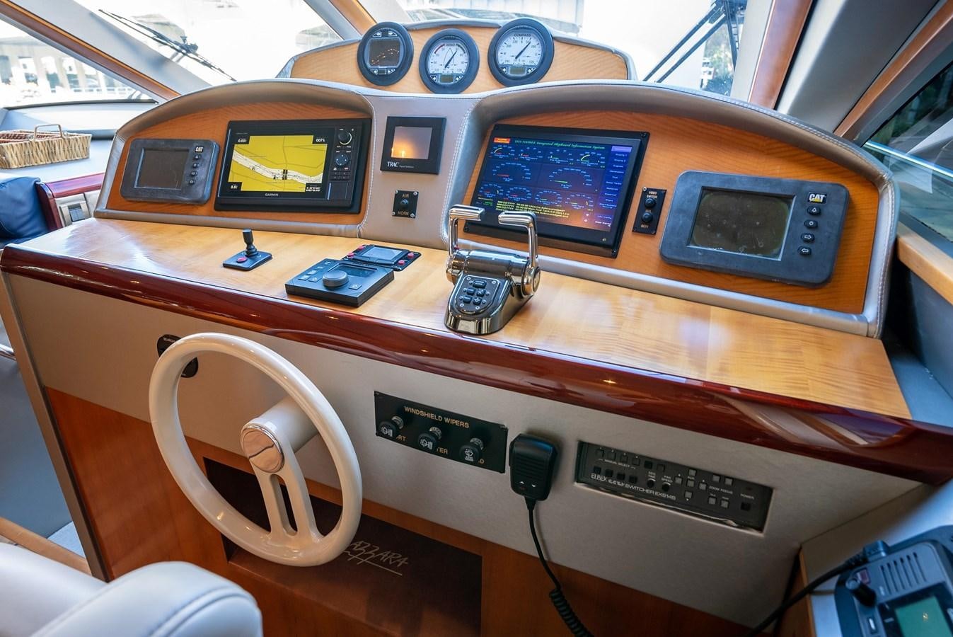 a wooden table with a clock and mugs on it aboard COMPROMISE Yacht for Sale