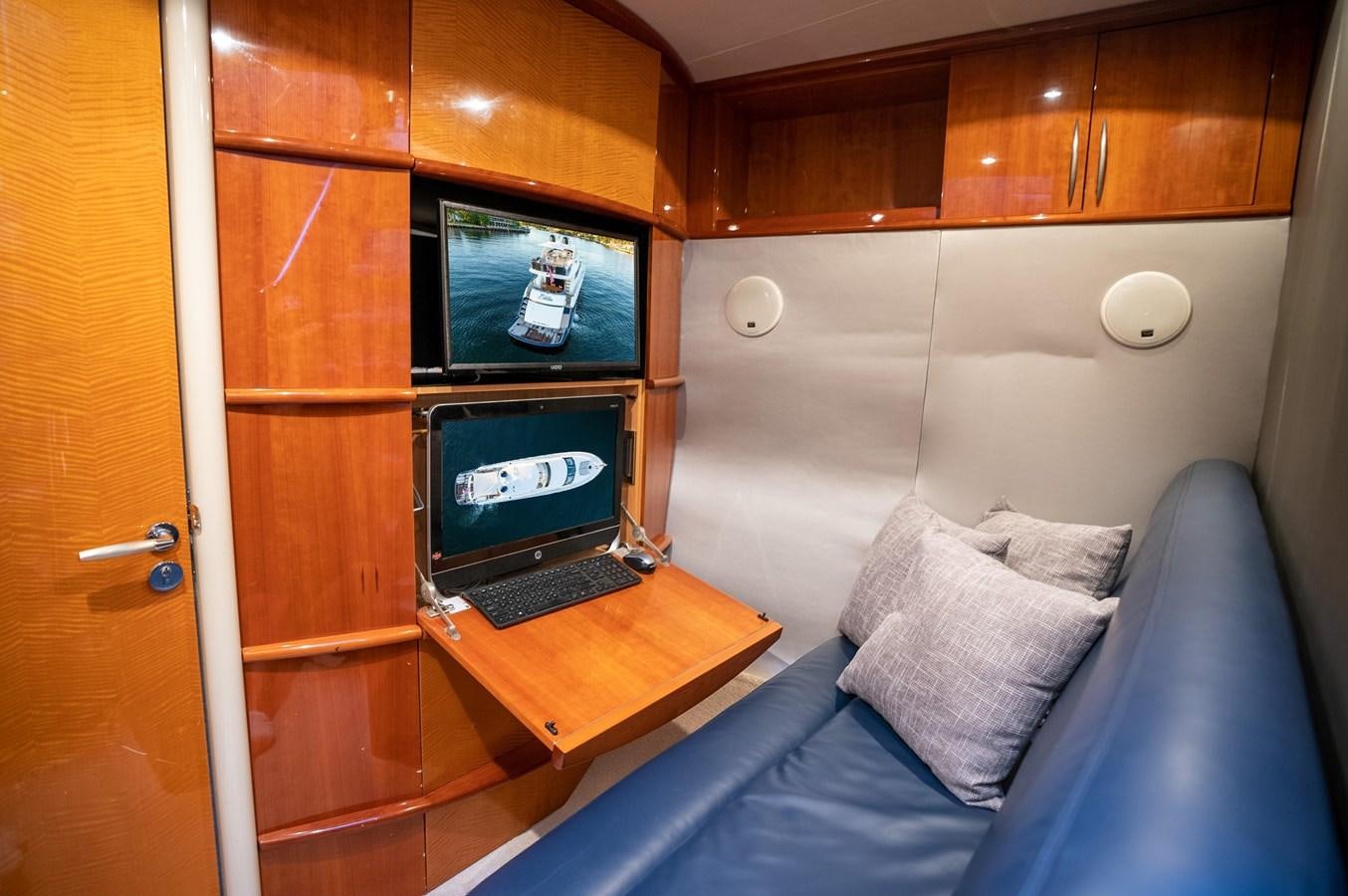 a bed with a desk and a computer on it aboard COMPROMISE Yacht for Sale