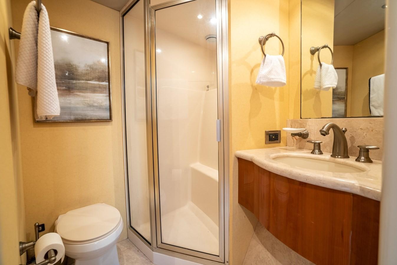 a bathroom with a glass shower door aboard COMPROMISE Yacht for Sale