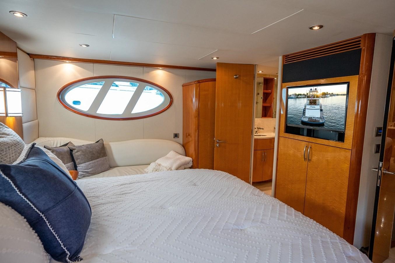 a bed with a white bed spread aboard COMPROMISE Yacht for Sale