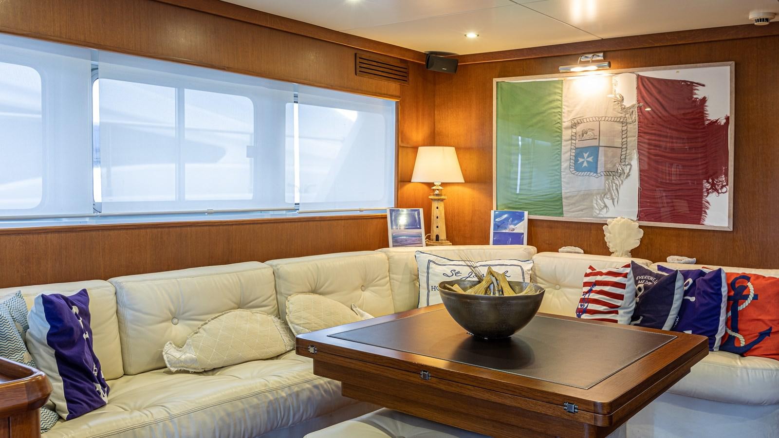 a living room with a couch and a coffee table aboard ORION  Yacht for Sale