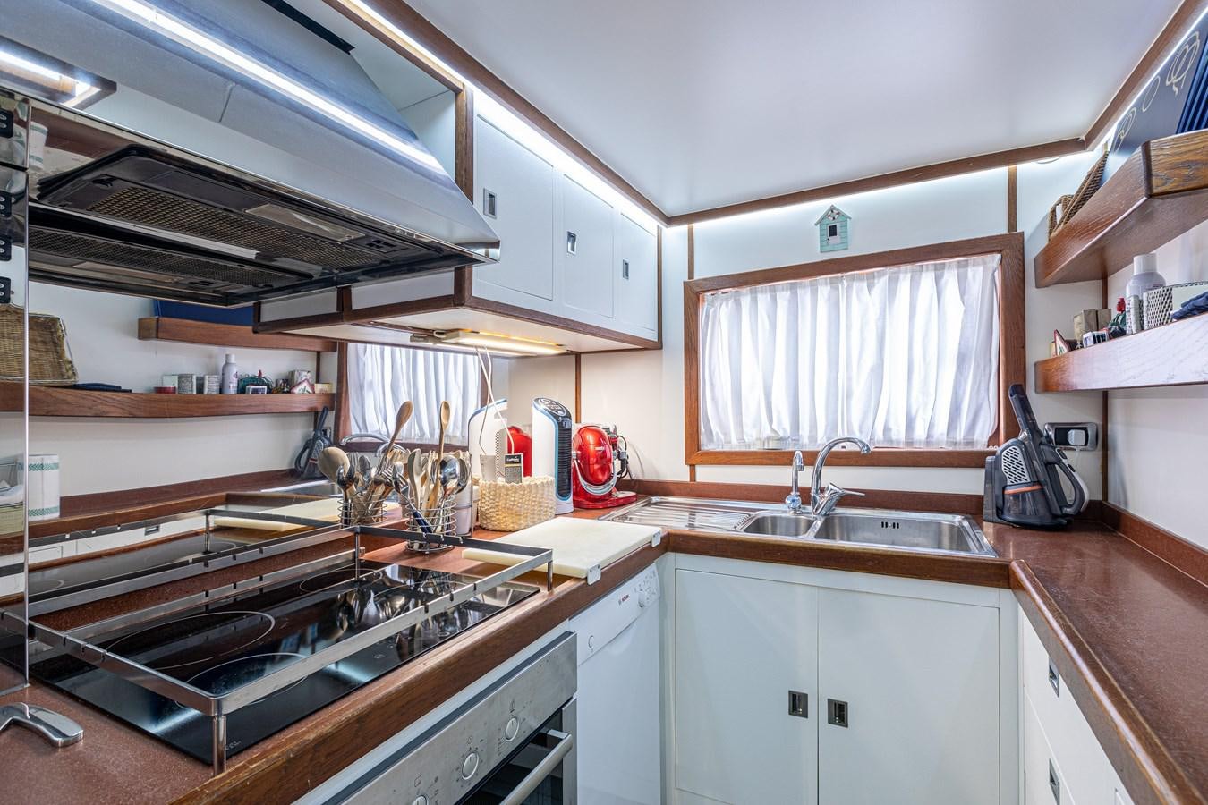 a kitchen with a stove and sink aboard ORION  Yacht for Sale