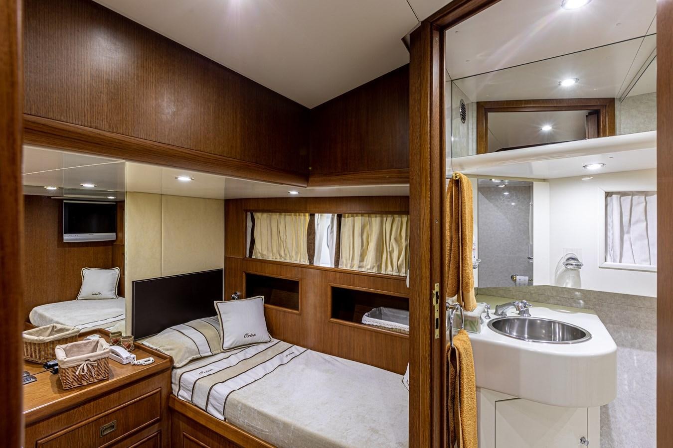 a bedroom with a bed and a sink aboard ORION  Yacht for Sale