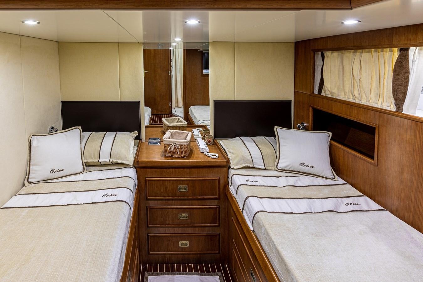 a room with beds and a dresser aboard ORION  Yacht for Sale