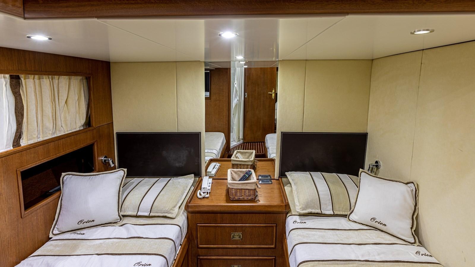 a room with a bed and a tv aboard ORION  Yacht for Sale