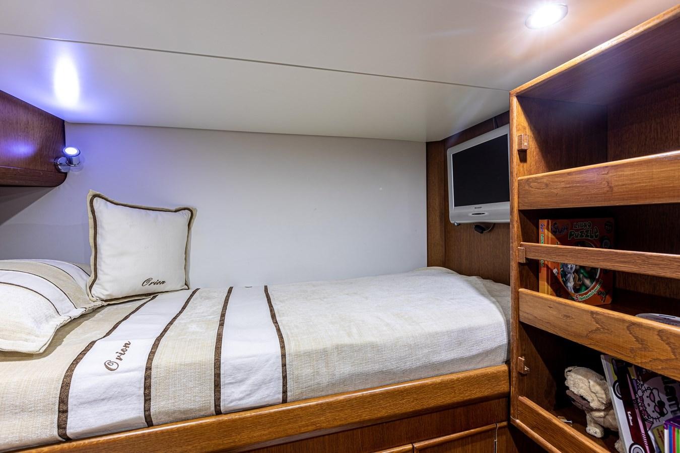 a bed with white sheets and pillows aboard ORION  Yacht for Sale