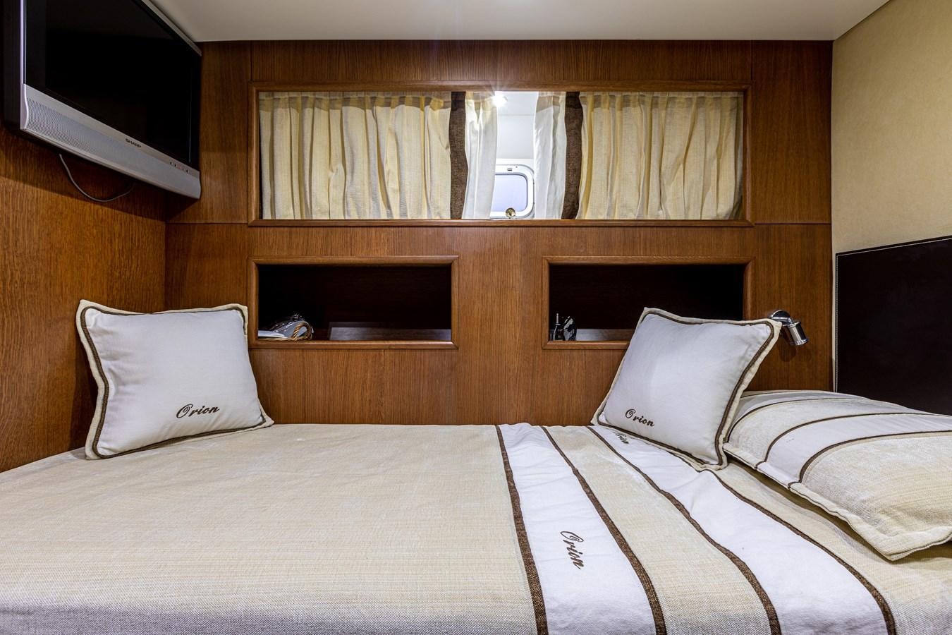 a bed with white sheets and pillows aboard ORION  Yacht for Sale