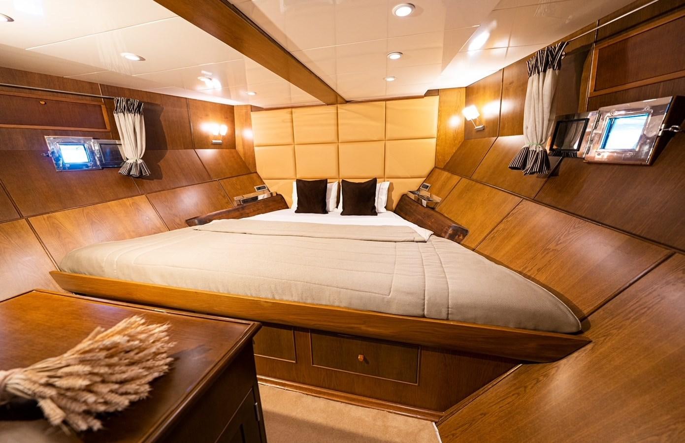 a room with a bed and a television aboard ARKTOS Yacht for Sale