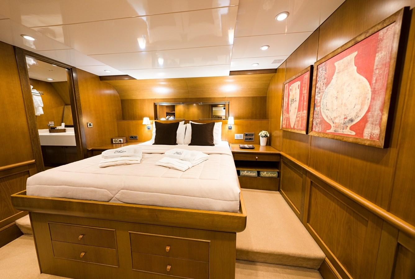 a room with a bed and a desk aboard ARKTOS Yacht for Sale