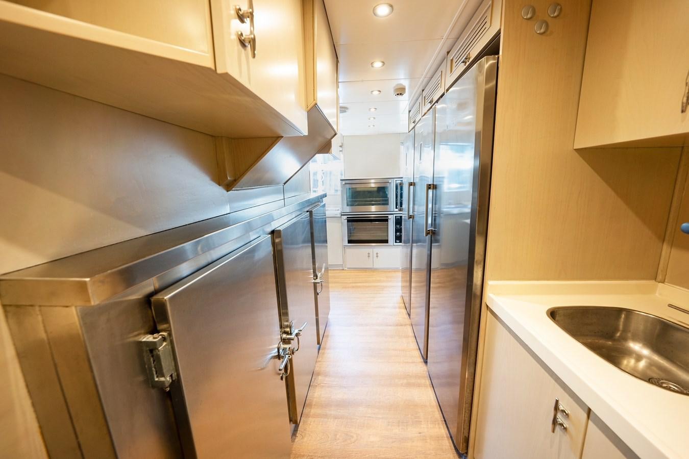 a kitchen with stainless steel appliances aboard ARKTOS Yacht for Sale
