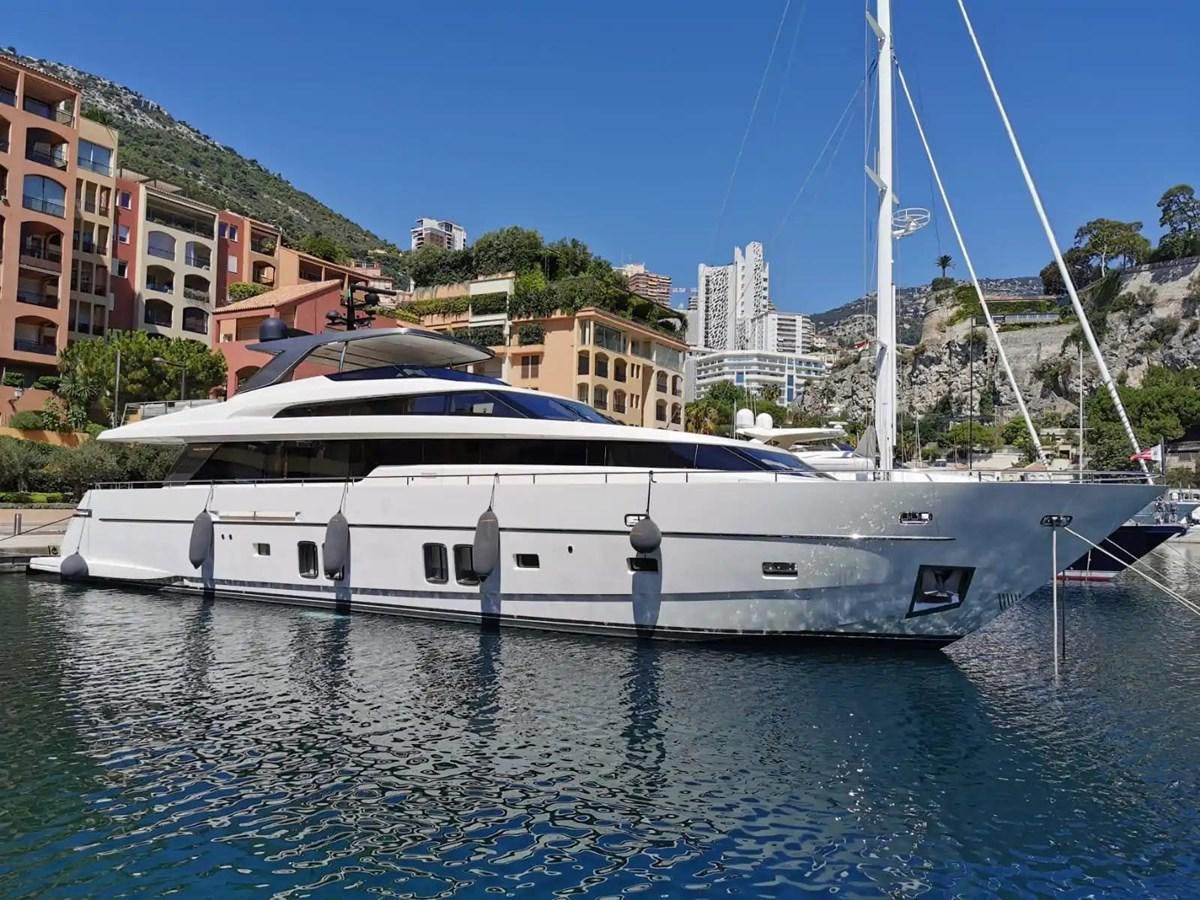 a white boat in a harbor aboard MUMA Yacht for Sale