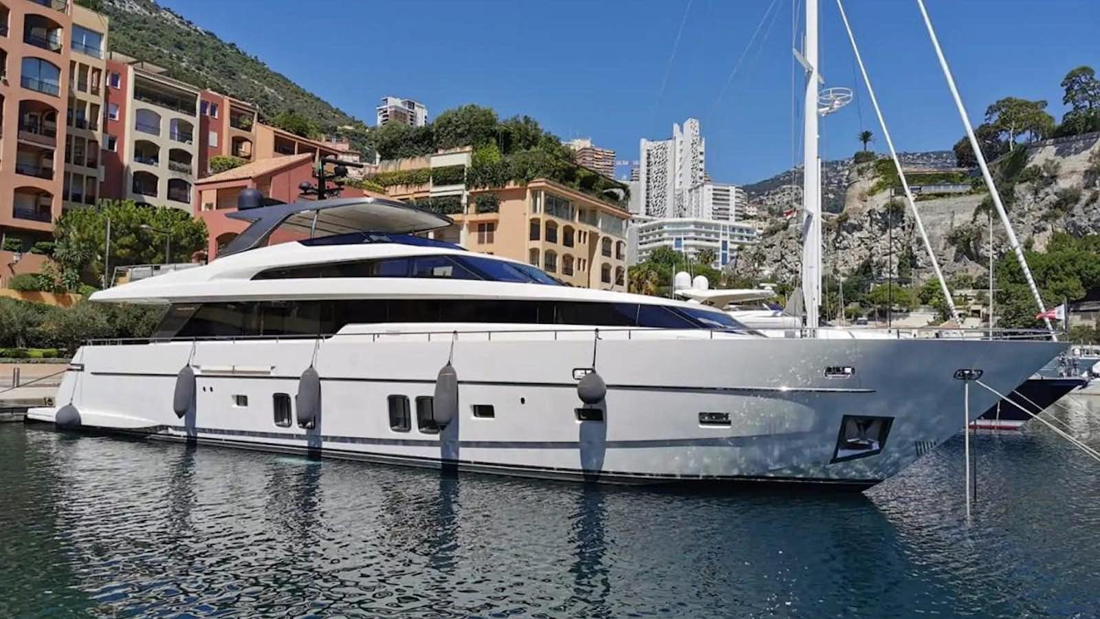 a white boat in a harbor aboard MUMA Yacht for Sale